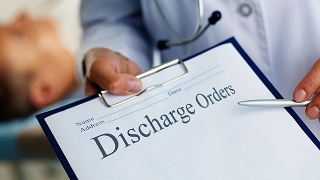 Discharge form on clipboard