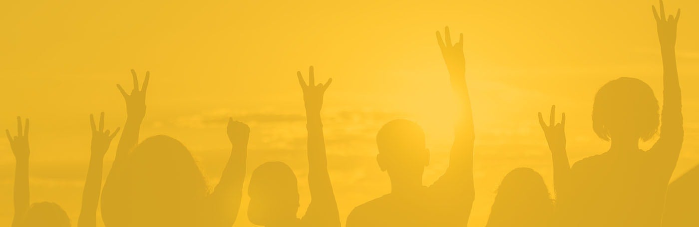 A silhouette of people with raised arms on a gold background