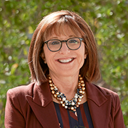 Dean Deborah Helitzer portrait wearing maroon and smiling