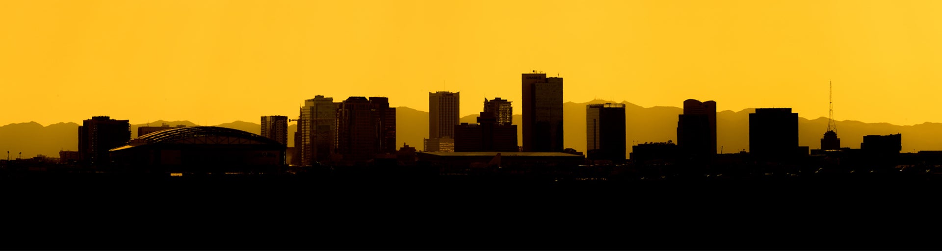 Downtown Phoenix silhouette with gold background