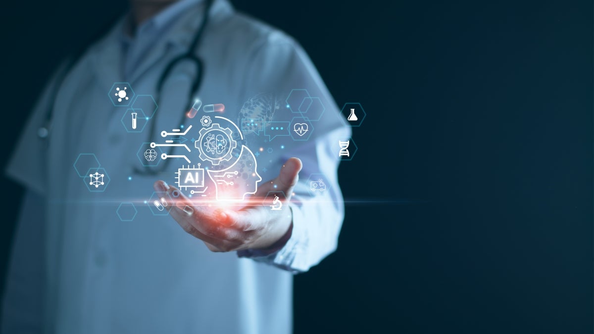 A medical professional holds a holographic display of AI and scientific symbols.