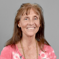 Carol Johnston portrait photo with gray background